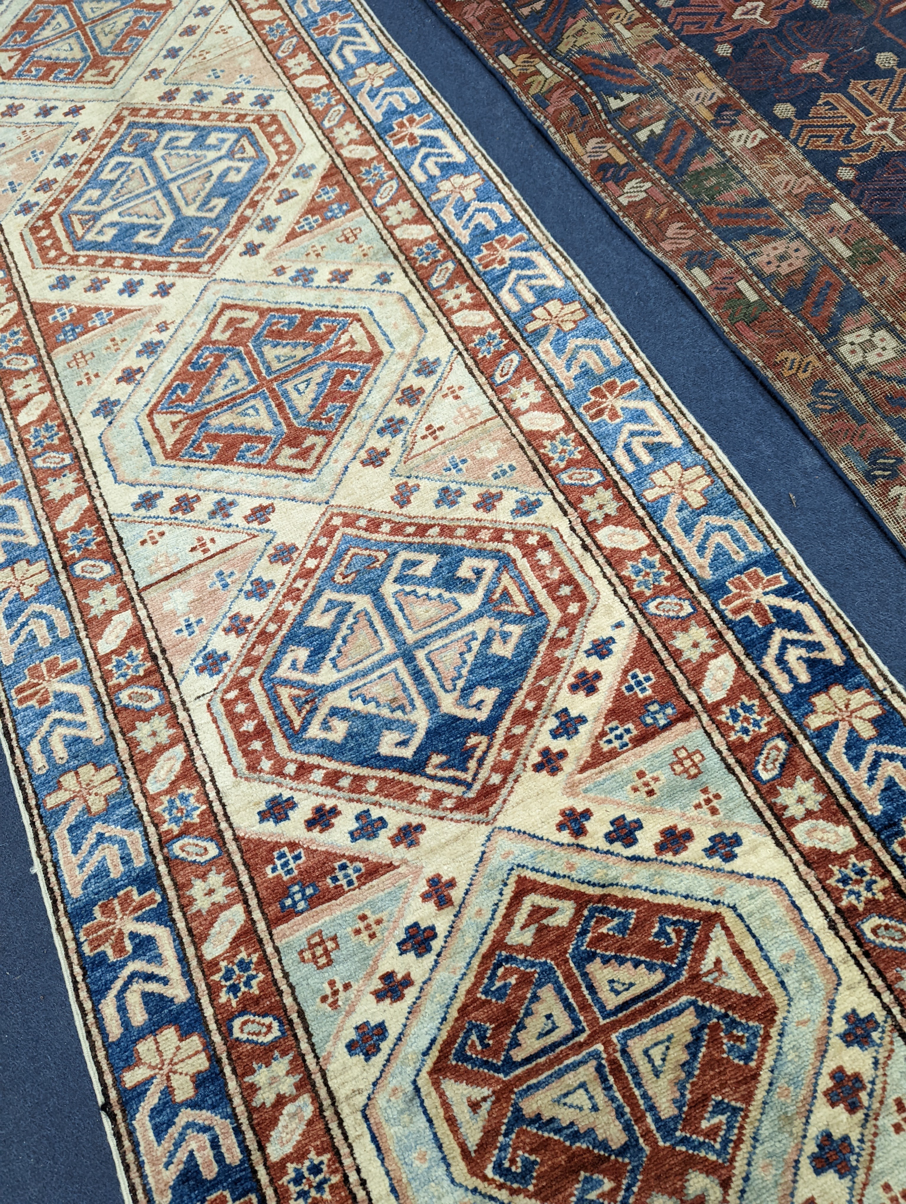 A Caucasian design ivory ground runner, 280 x 70cm